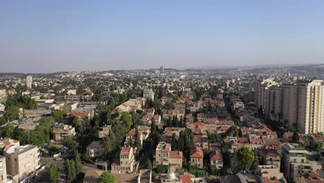 Jerusalem-city-view,-neighborhood-view,-buildings-in-green-wood,-aerial-view