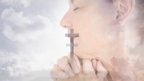praying woman with hands clasped, cross animation overlay and cloudy sky background