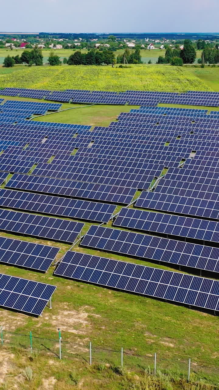 Solar energy panels in nature. Green energy conservation ecology. Renewable green alternative energy concept. Aerial view. Vertical video
