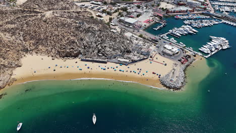 drone shot of cabo san lucas public beach outside city harbor, coastline and landscape, baja california, mexico