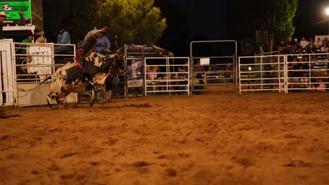 bull riding event at an outdoor rodeo arena