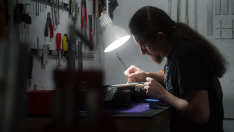 luthier repairing a guitar in a workshop
