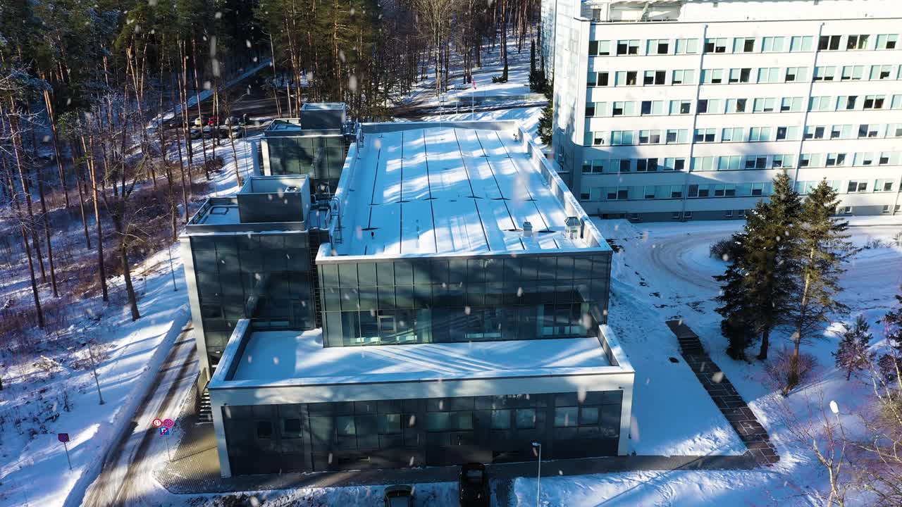 Rehabilitation center building exterior in winter, modern medical facility in aerial view
