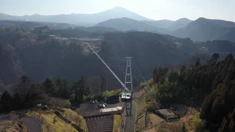 Descending-drone-shot-into-the-sun-of-the-suspension-bridge-Kokonoe-Yume-Otsurihasi