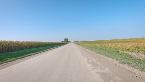 Double-time-POV-while-driving-on-a-gravel-country-road-in-rural-Iowa-in-late-summer