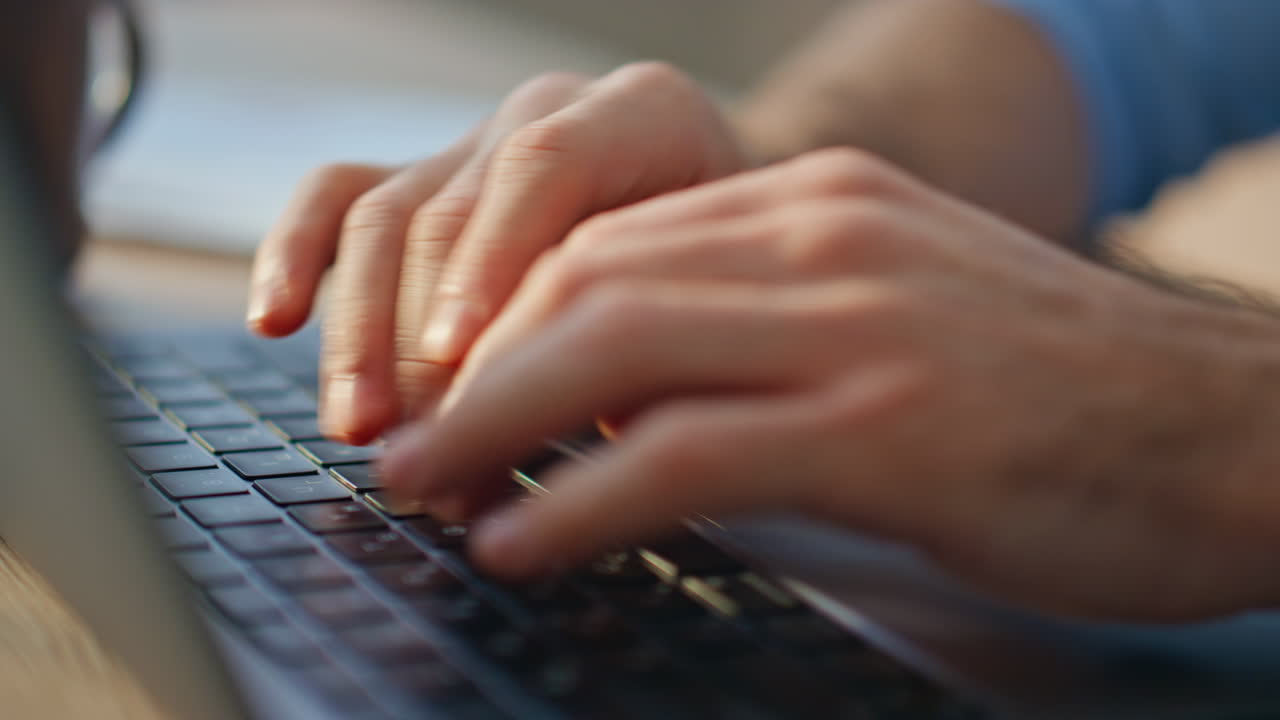 Closeup person typing laptop in sunlight. Man hands using touchpad in office.