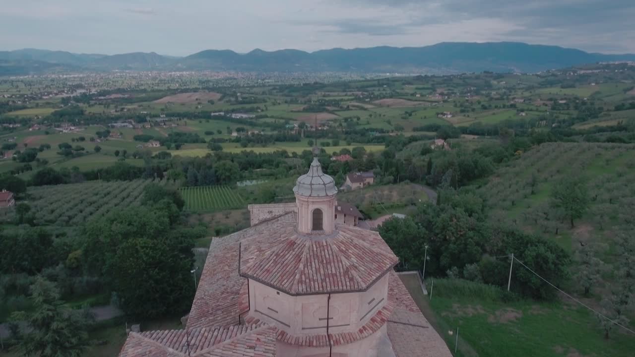 Aerial Drone shot Crane Down and Tilt Up onto Church from Countryisde in Umbria, Italy