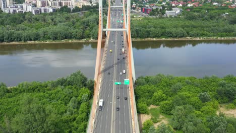 Car-driving-on-highway-bridge-and-road-intersection-in-modern-city-aerial-view