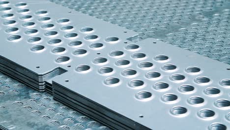 Metal-plates-with-perforations.-Steel-blanks-with-holes-at-warehouse-of-factory