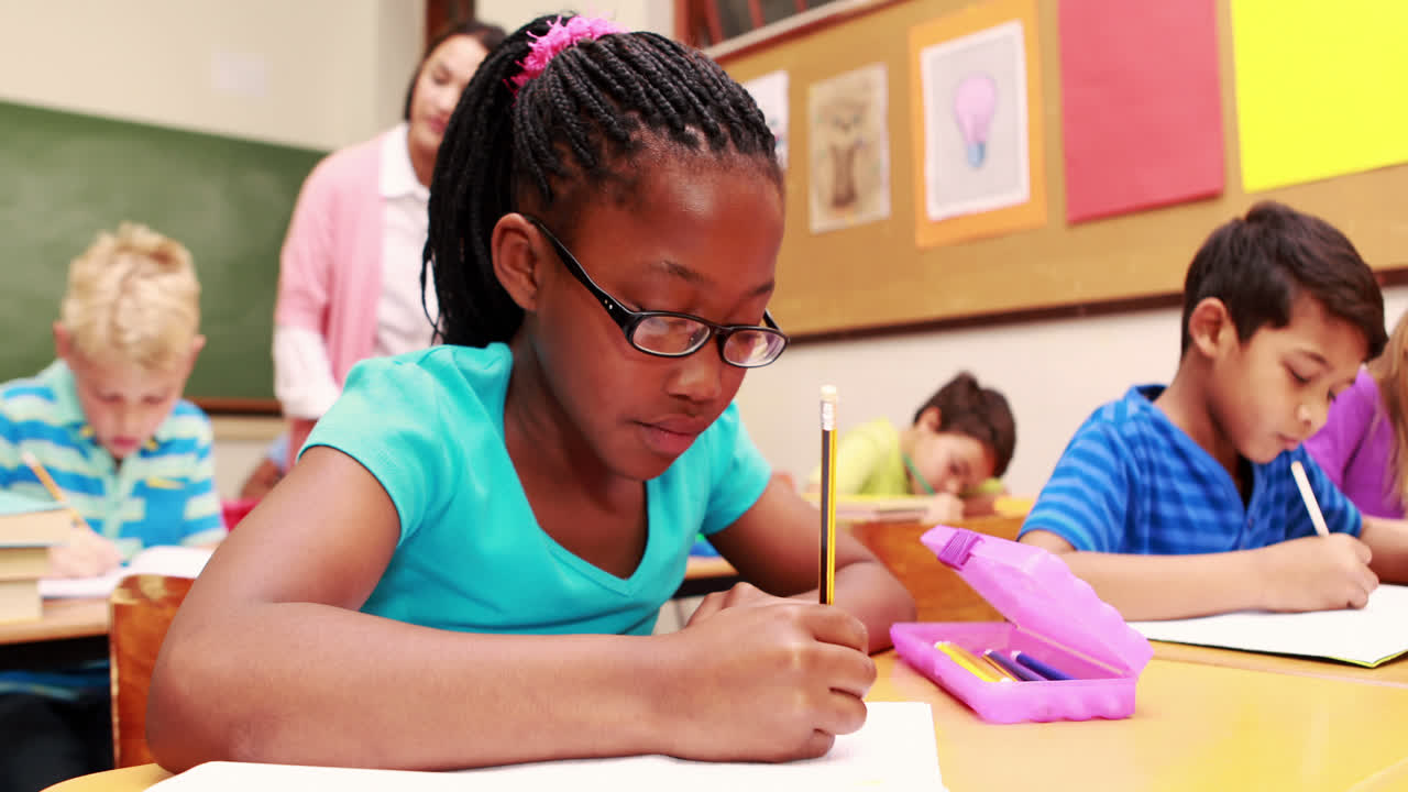 Young little girl drawing with pencil