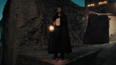 mysterious woman with cloak and lantern explores a night city