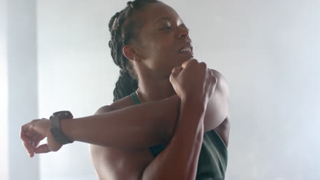 stretching arms, strong fit woman in gym wearing fitness attire, preparing for workout