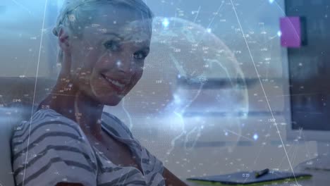 Network-of-connections-and-globe-over-portrait-of-caucasian-woman-smiling-while-using-digital-tablet