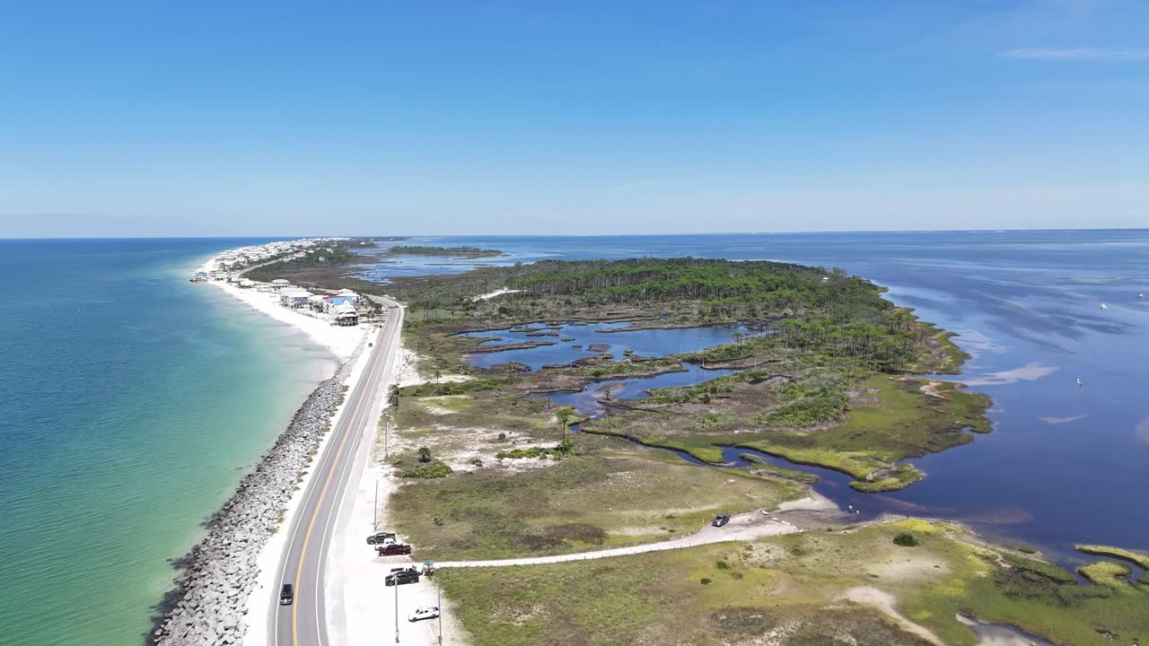 Drone orbit at coastal wetlands with sandy shoreline near the main road in beauty environment, Cape San Blas, Gulf County, Florida, USA