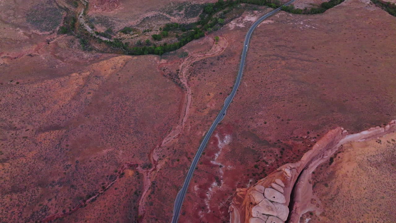 Following the highway going through the desert plain among the canyons. Zion National park in Utah, USA. Aerial perspective.