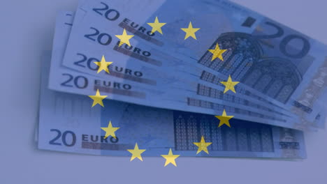 Yellow-stars-spinning-against-Euro-bills-lying-on-a-table