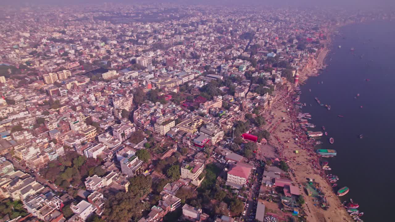 Varanasi city view through ganga river with varanasi ghats or kashi ghats at banaras, kashi, uttar pradesh, india. day time, orbit shot, drone shot, 4k.