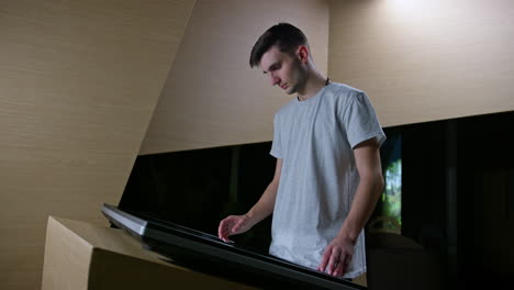 adolescent boy making hand gestures on the touch screen display, medium shot