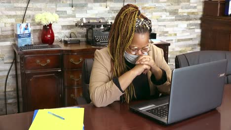 African-American-business-owner-bowing-her-head-while-working-to-ask-God-for-guidance-and-strength