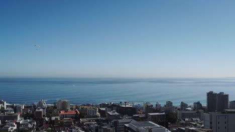 Paragliders-flying-by-the-seaside,-Seapoint-Cape-Town-4K