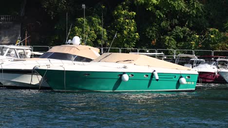 green boat docked by the shore in sorrento