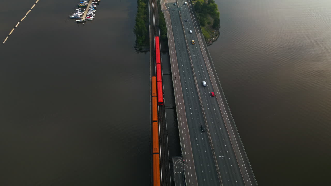 Two suway metro cars meeting on a bridge leading to Helsinki