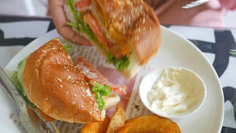 a person eating a burger and fries