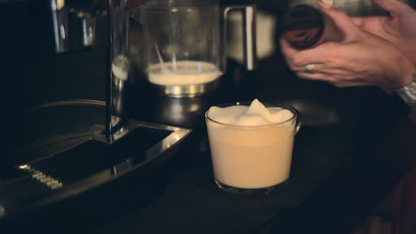 preparing a latte with coffee machine