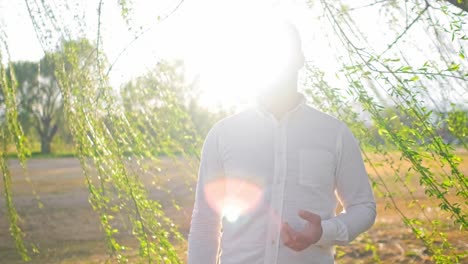 adult singer man singing under a weeping willow tree at a gold course in washington dc during a gorgeous sunset