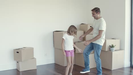 Active-dad-and-daughter-celebrating-moving