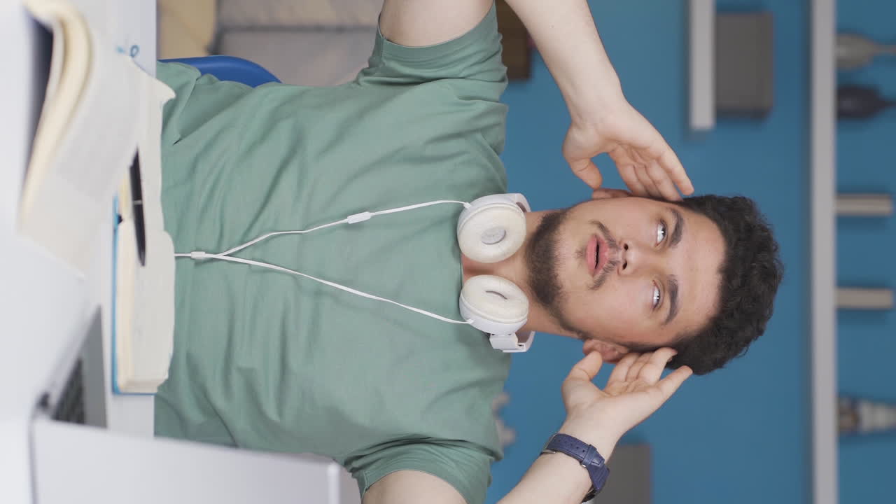 편두통을  ⁇ 고 있는 남학생의 수직 동영상