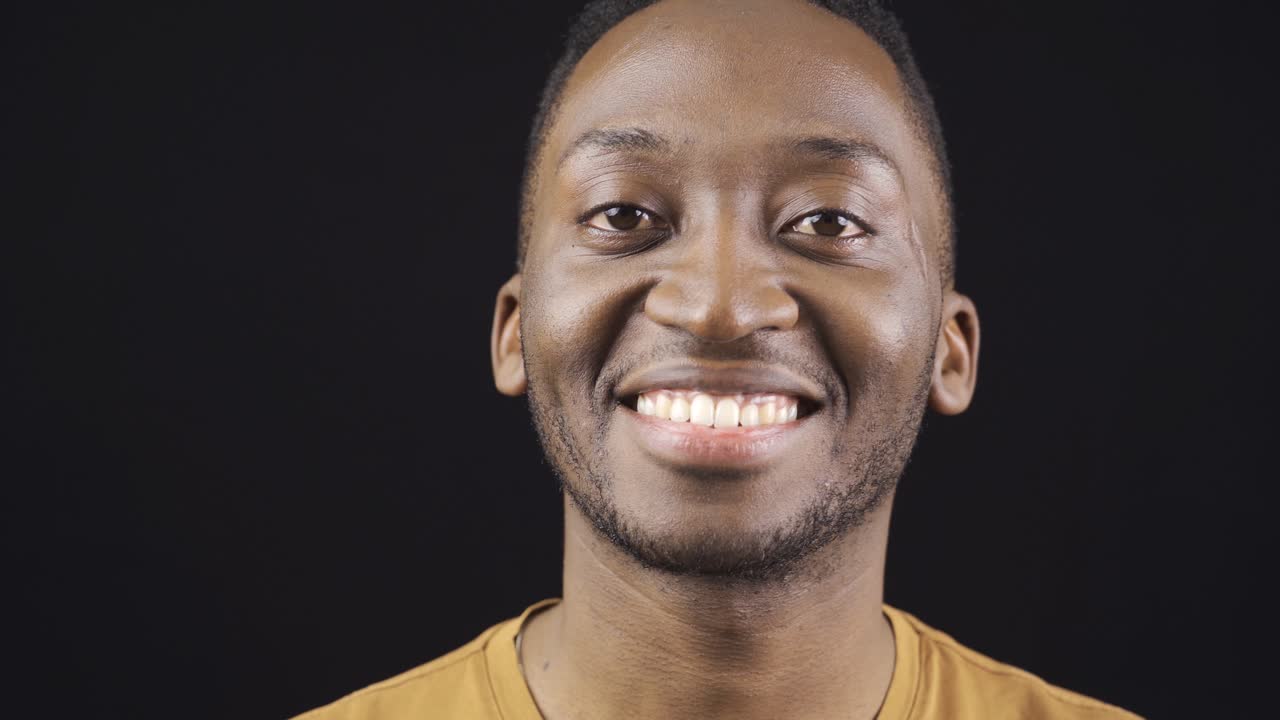 Close-up portrait of smiling friendly african young man.