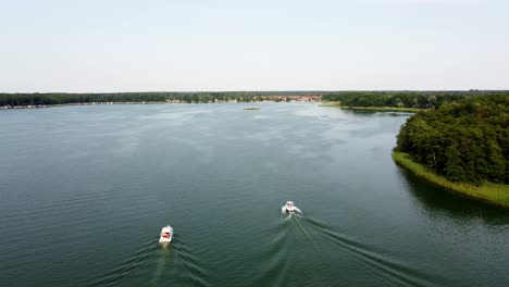 several motor boats racing on a large lake in brandenburg, germany