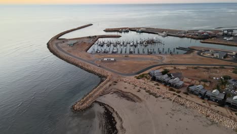 Drone-aerial-moving-towards-exmouth-boat-harbour-during-dawn