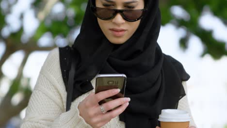 woman in hijab using mobile phone 4k