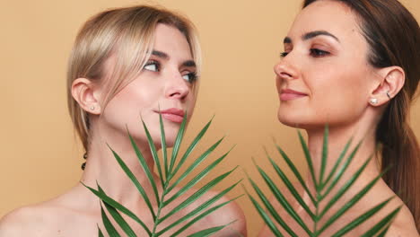 two women portrait with palm leaf