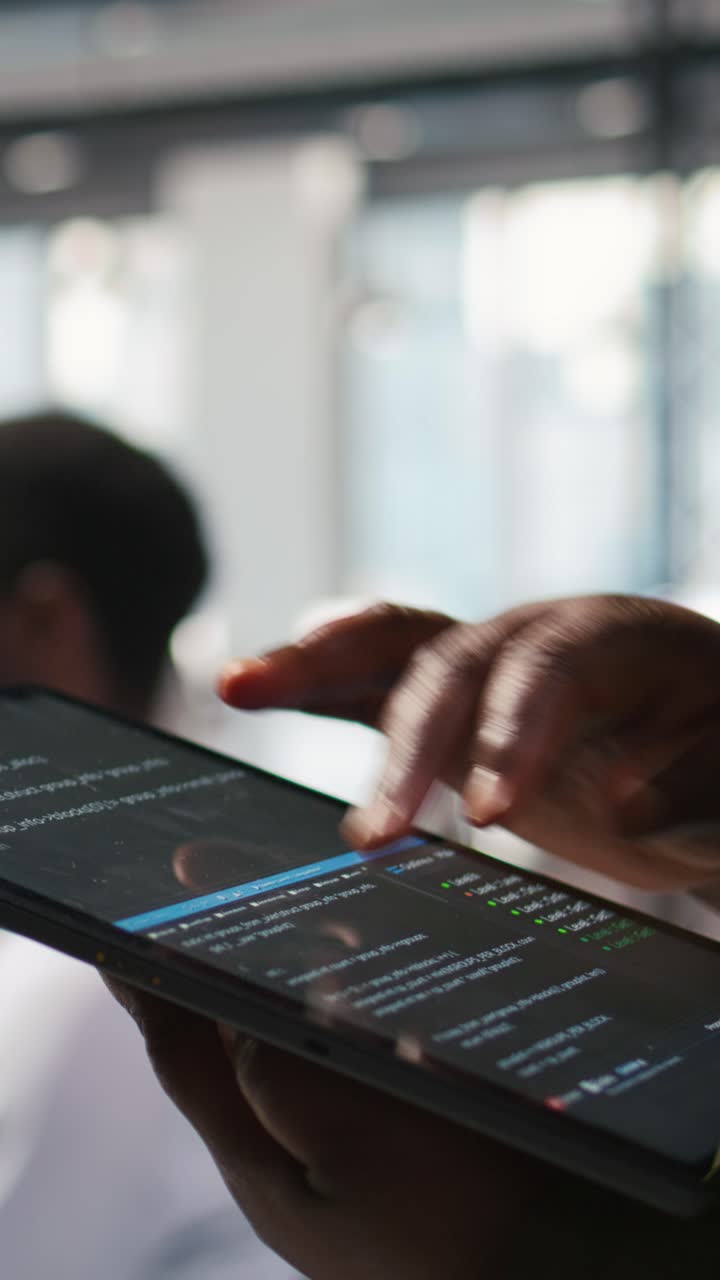 Vertical video Close up of programmer utilizing AI on tablet to optimize performance