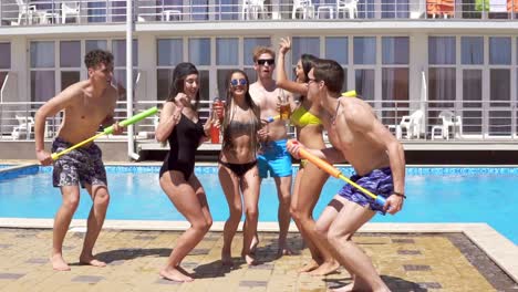 Happy-Young-Cheerful-Friends-Dancing-And-Having-Fun-At-The-Pool