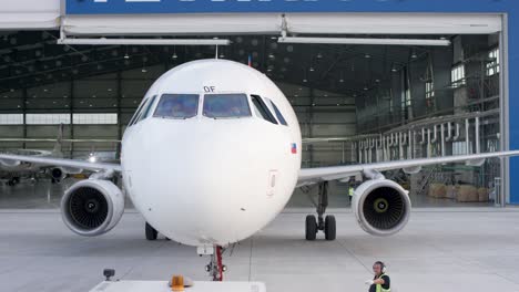 airplane in hangar undergoing maintenance