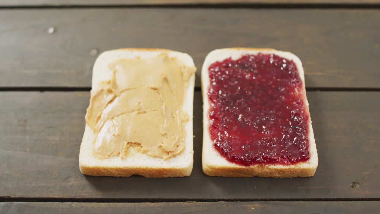 Nærbillede af en peanutbutter- og syltetøjssandwich med tekstplads på en træoverflade