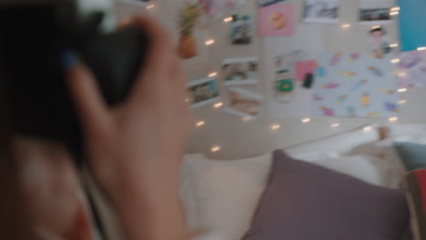 happy teenage girls taking photos together using instant photo camera best friends hanging out at home on weekend enjoying friendship