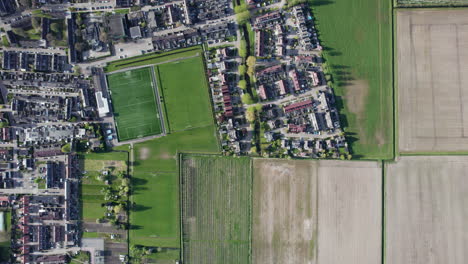 bird's eye view over klaaswaal village and scenic meadows in the netherlands - drone shot