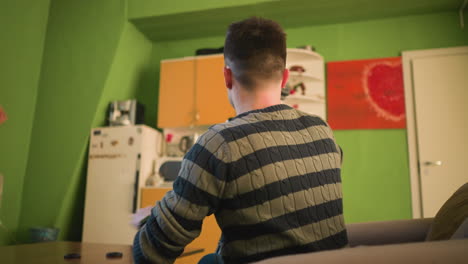broadcast director adjusting camera and microphone setup in home studio. preparing for video shoot with camera gear and accessories arranged on table, ready for production