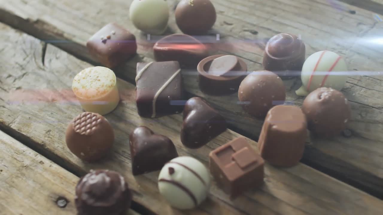 animación de la luz sobre pralinas de chocolate en superficie de madera