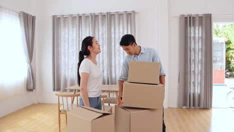 asian couple in new house at moving day