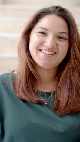 vertical video portrait of plus size biracial woman smiling at home, slow motion