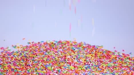 vibrant sprinkles cascade onto a growing mound