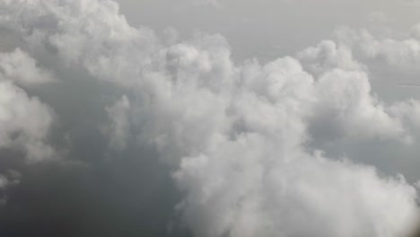 aerial view from airplane of clouds, ocean, cloudy sky over dubai