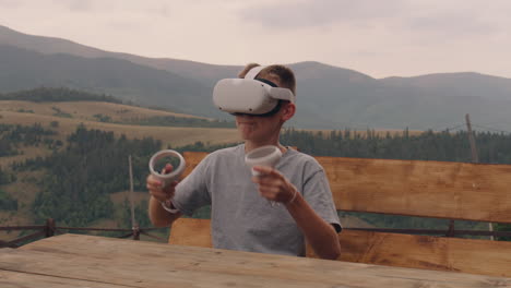 boy playing vr games in the mountains
