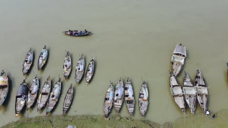 numerous boats are moored on the river